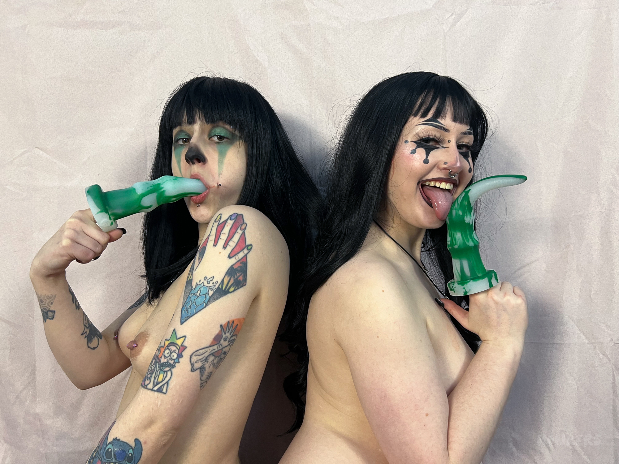 Two clowns play with fantasy dildos